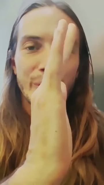 Keith close to the camera, one hand near his face